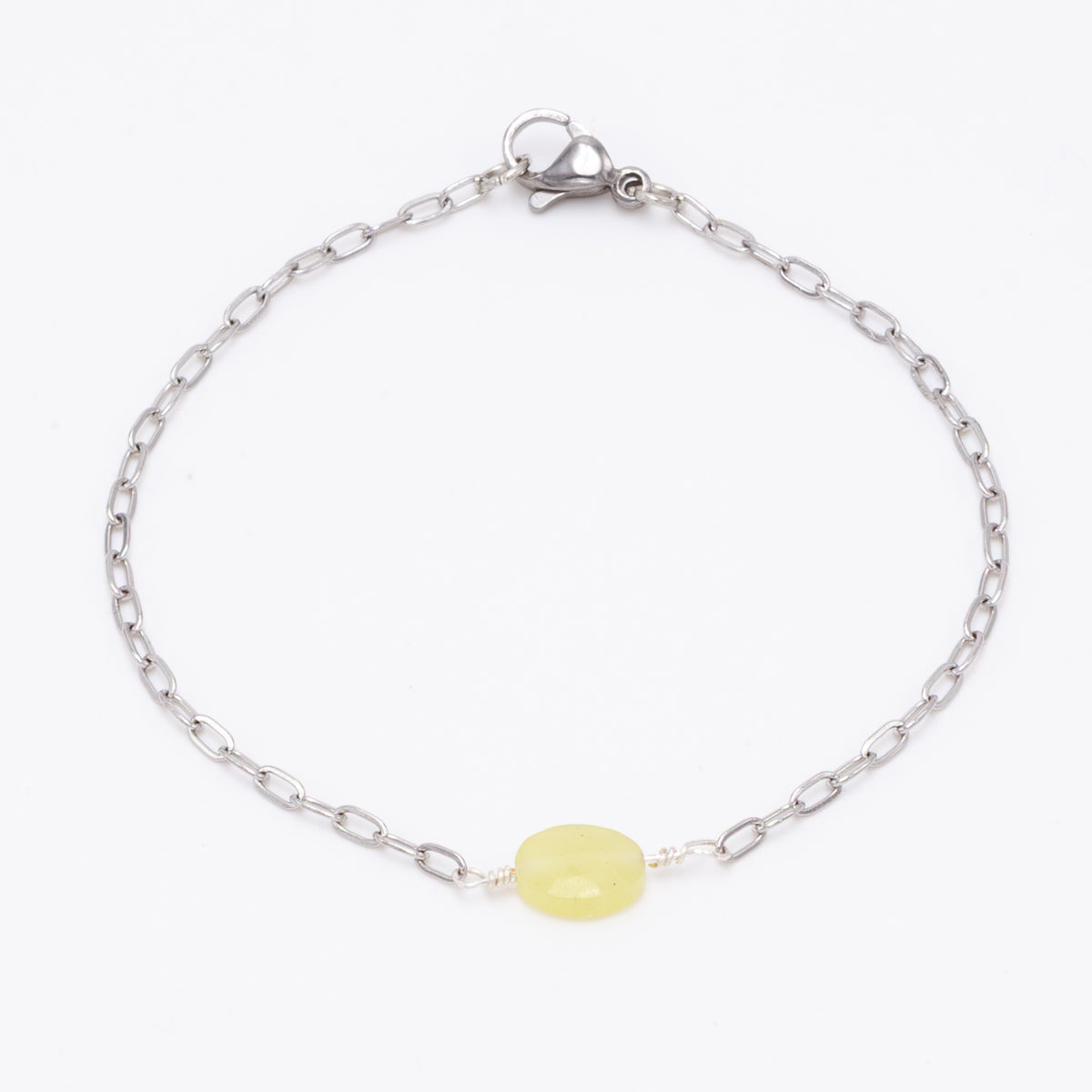 stainless steel silver bracelet with faceted 6mm yellow jasper bead with hand twists on white background
